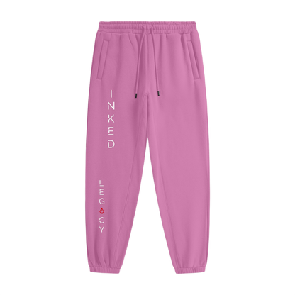 Pink sweatpants with 'Inked Legacy' text on a white background