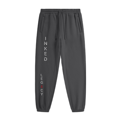 Dark gray sweatpants with 'Inked Legacy' text on a white background